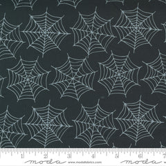 White spider webs on black fabric