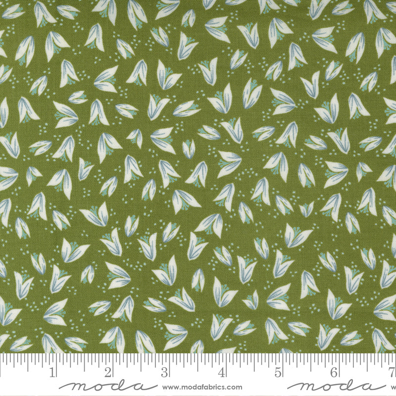 A print fabric of ivory flower buds on green