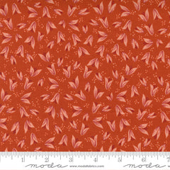 A print fabric of peach flower buds on red