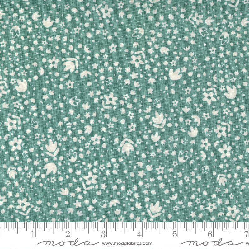 A tiny floral print fabric in white on dusty teal
